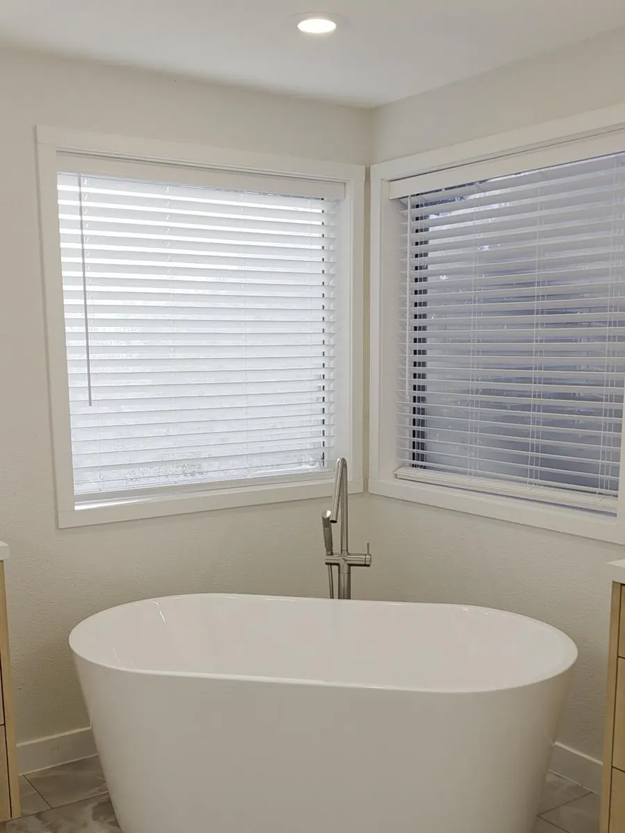 Same corner finished with a new freestanding tub and fresh walls