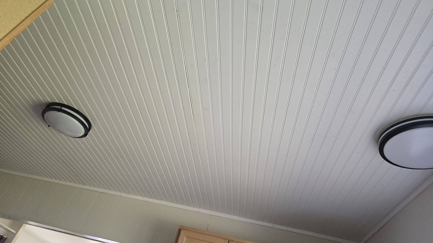 White beadboard ceiling finished around two new light fixtures