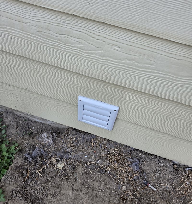 New louvered dryer vent installed on lap siding