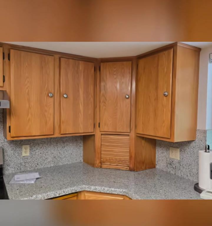 Oak corner cabinets with a worn finish, the kind of kitchen a refresh brings back