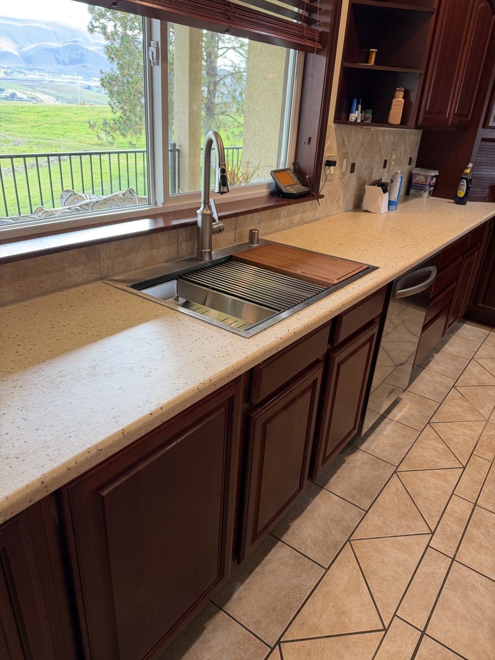 Finished Kennewick bathroom remodel by Speedy's Handyman: wood vanity with quartz top and new tile floor