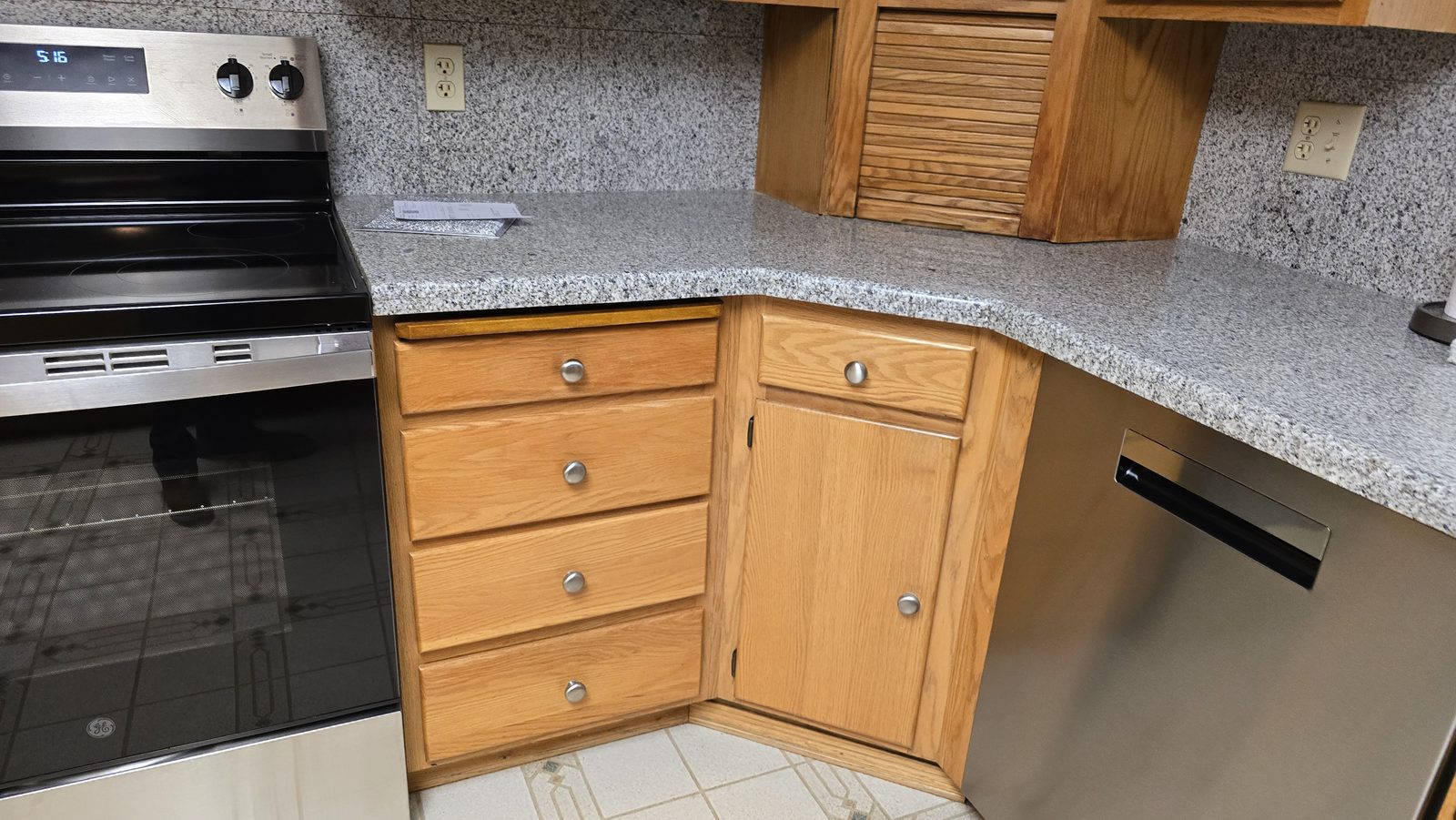 Oak corner cabinets and drawers with the worn finish blended back in, after a Speedy's kitchen refresh