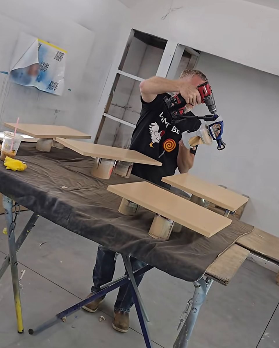 James Hoidal in the Speedy's paint booth with cabinet doors set up on stands