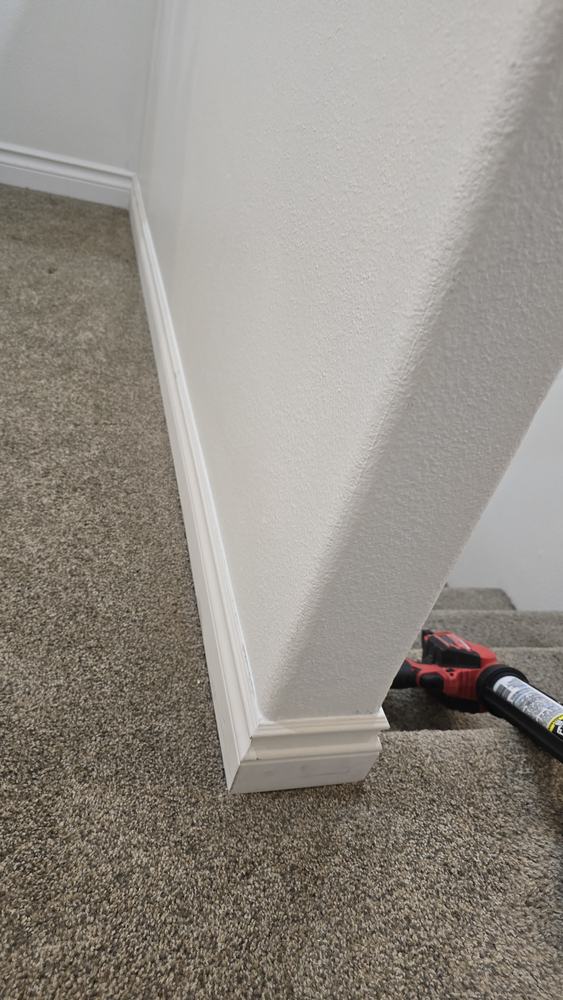 Baseboard corner repaired and blended into the existing finish