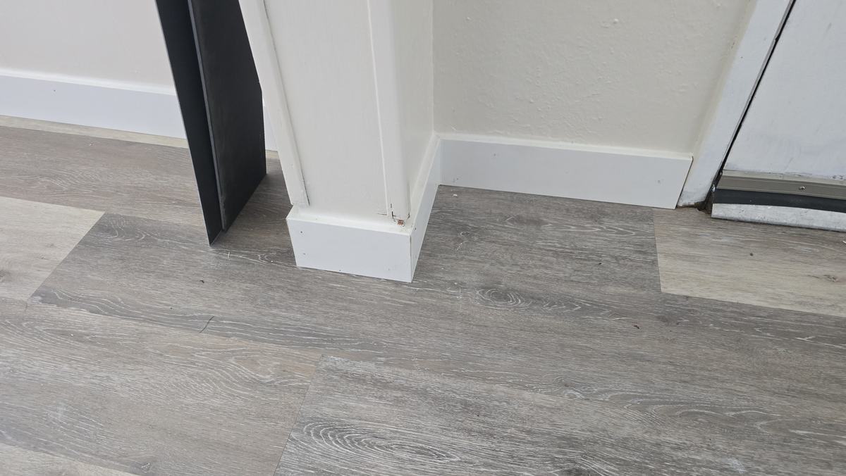 Freshly painted door casing and baseboard trim