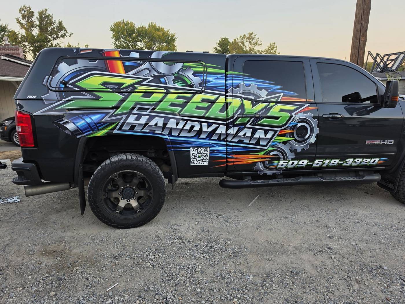 Speedy's Handyman work truck with its green, blue and black wrap
